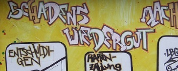 Grafitti mit der Aufschrift "Schadenswiedergutmachung"